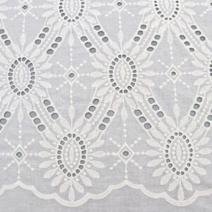 A white lace tablecloth featuring a large floral design, made from Pearl Medallion Eyelet cotton lace fabric