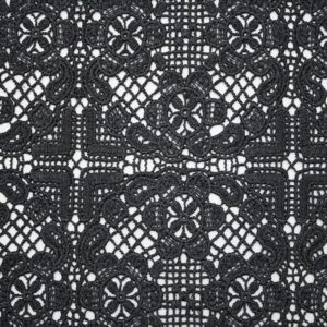 Black and white photo showcasing an intricate polyester lace pattern with delicate floral designs
