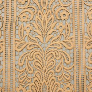 Close-up of a polyester lace pattern on a wall, showcasing intricate designs and textures