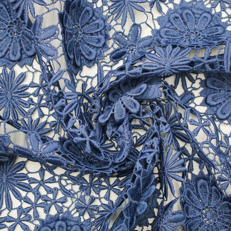 Elegant blue lace fabric with floral and leaf motifs, crafted from polyester material