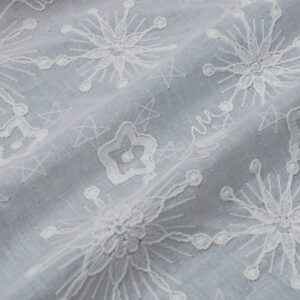 Embroidered white cotton fabric showcasing a decorative pattern