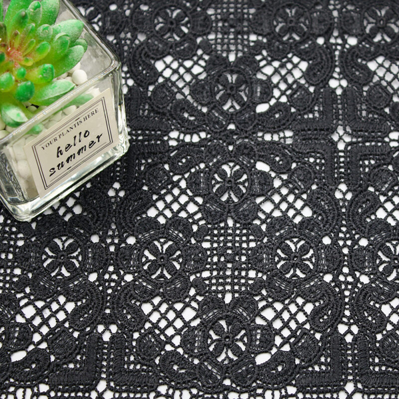 A black and white image featuring a detailed lace pattern made of polyester, highlighting its elegant texture