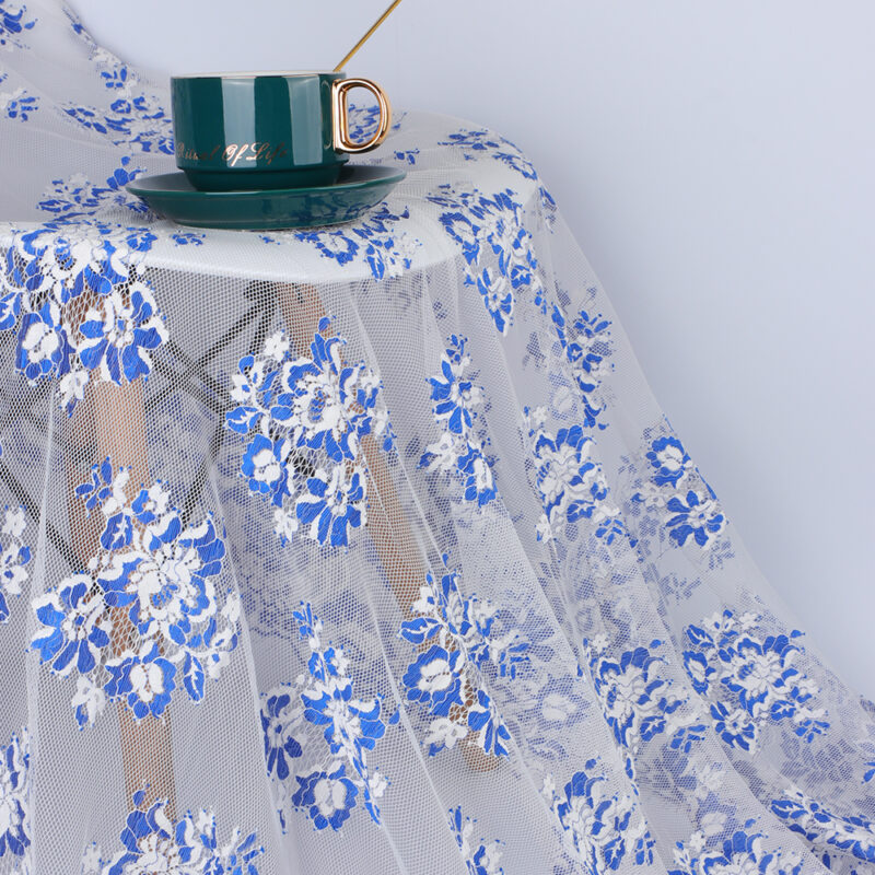 A blue and white floral nylon lace tablecloth with a cup placed on top