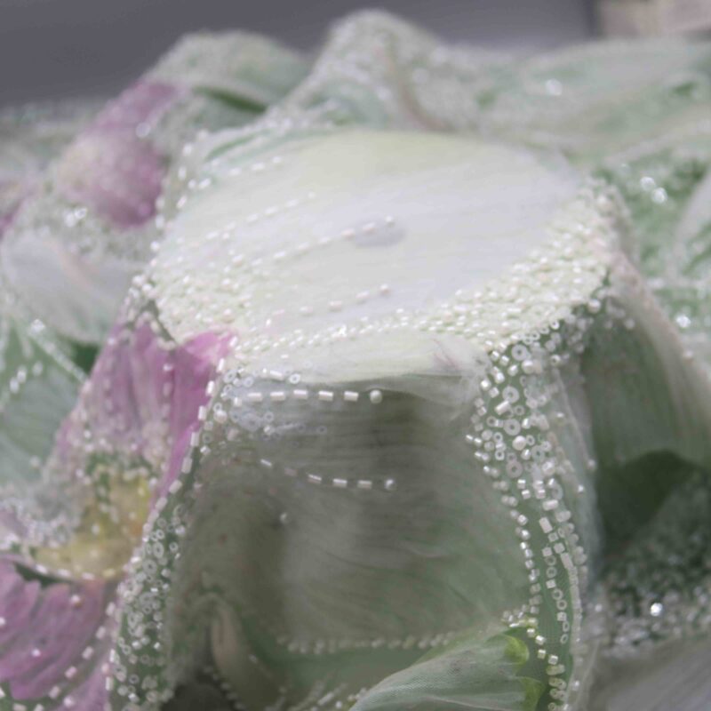 A purple flower painting embellished with pearls, featuring a backdrop of intricate polyester beaded lace fabric