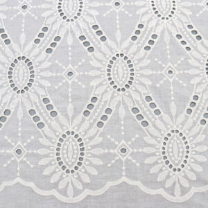 A white lace tablecloth featuring a large floral design, made from Pearl Medallion Eyelet cotton lace fabric