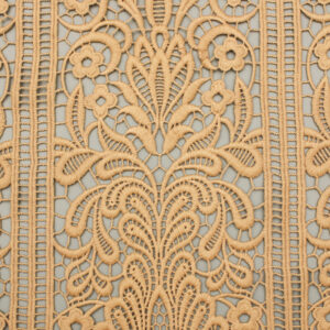Close-up of a polyester lace pattern on a wall, showcasing intricate designs and textures