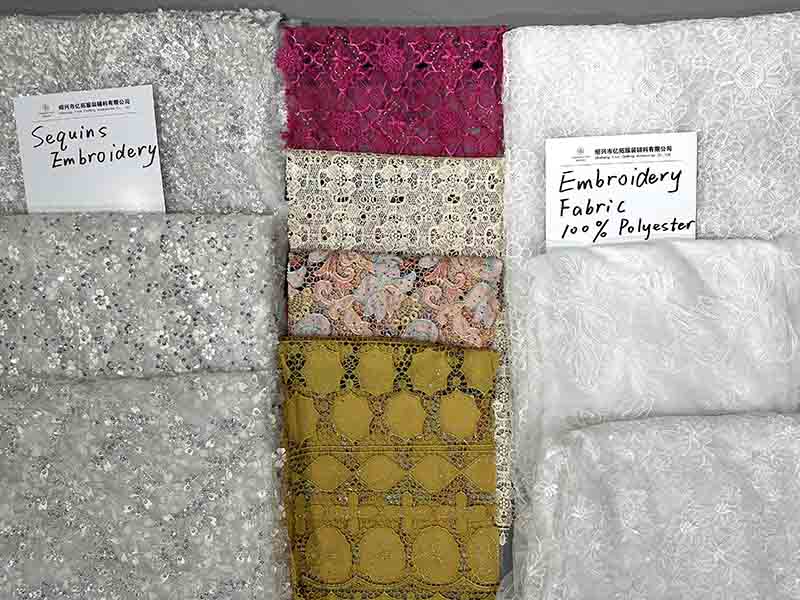 Close-up of white sequin polyester lace fabric featuring intricate floral patterns