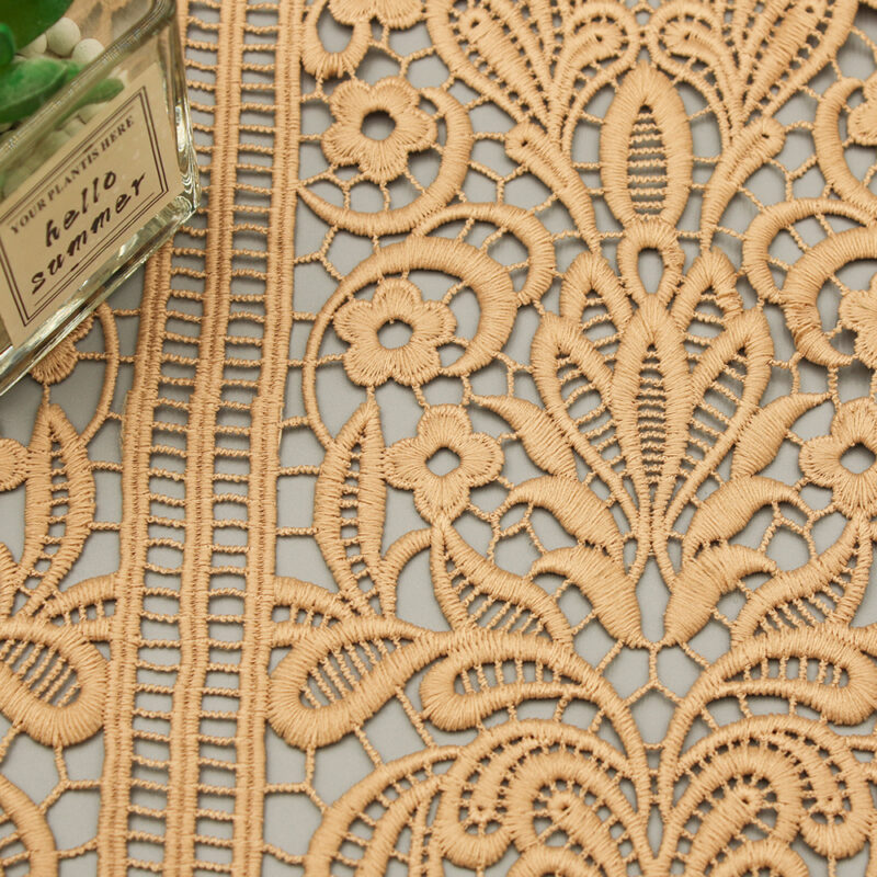 Detailed view of a lace pattern made from polyester, displayed on a wall, highlighting its delicate design