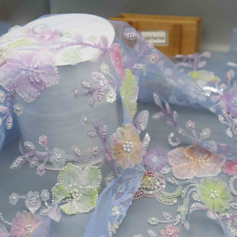 Detailed view of floral-patterned polyester lace fabric adorned with sparkling sequins