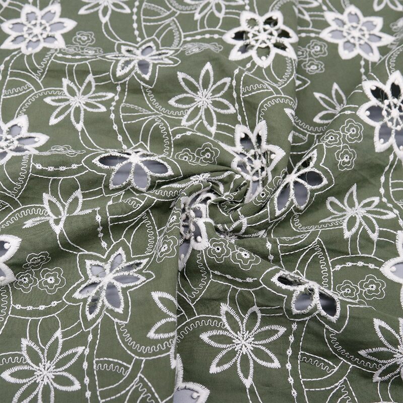 Green and white floral print cotton lace fabric, featuring delicate flowers on a textured background