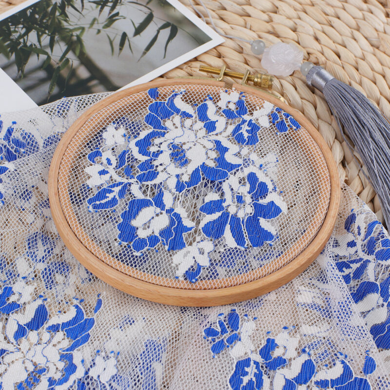 Nylon lace fabric in blue and white, showcasing a floral pattern with elegant lace detailing