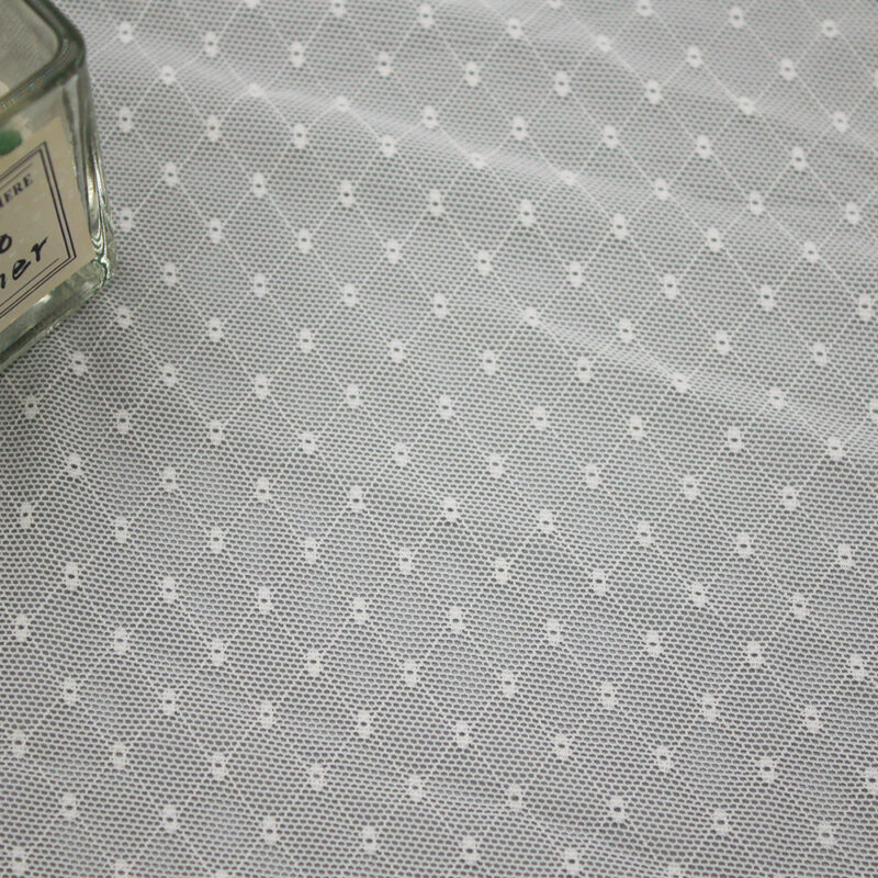 Small dot pattern on white and grey nylon and spandex lace fabric