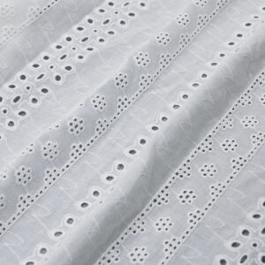 White cotton lace fabric featuring small holes and dots, creating a delicate and intricate pattern