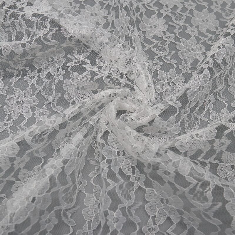 White nylon lace fabric featuring a large floral pattern, showcasing intricate details and delicate design