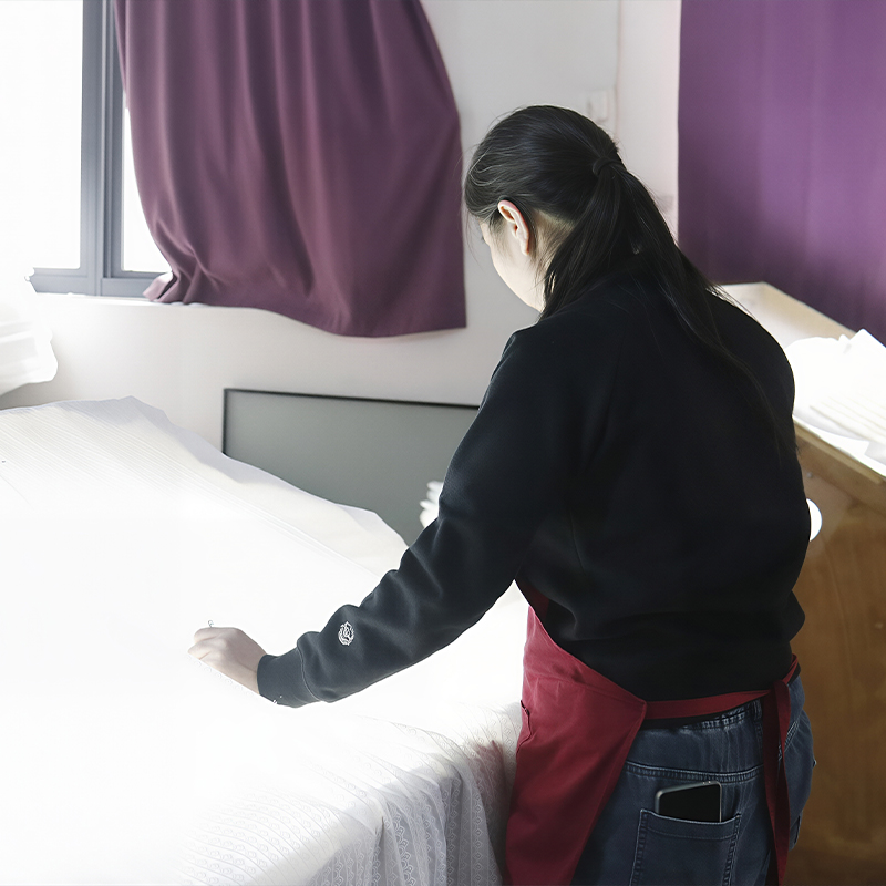 a worker is checking lace fabric quality